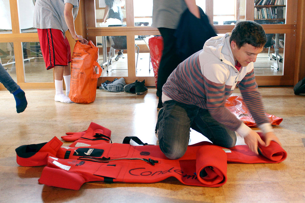 Port Townsend Junior Max Villagran works on packing up his immersion suit during a lesson of the Maritime Academy Skills Center class at the Port Townsend Maritime Center. (Zach Jablonski/Peninsula Daily News)