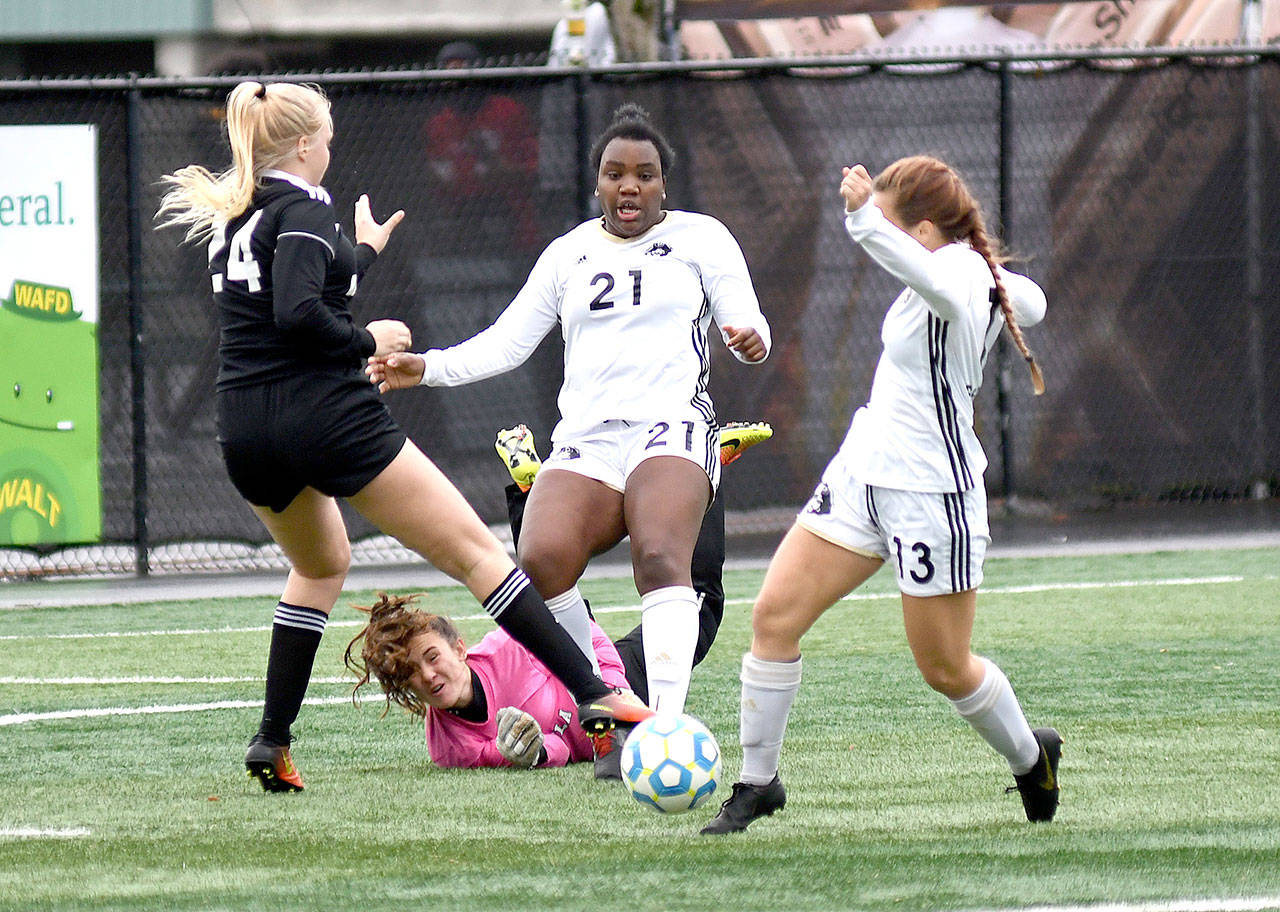 Photo courtesy of Peninsula College Peninsula’s Tonnylia Dunbar (21) and Grace Hipke (13) battle for possession along with Pirates’ goalkeeper Andrea Kenagy and a Highline player in Sunday’s NWAC championship. Highline scored in overtime to win 1-0.