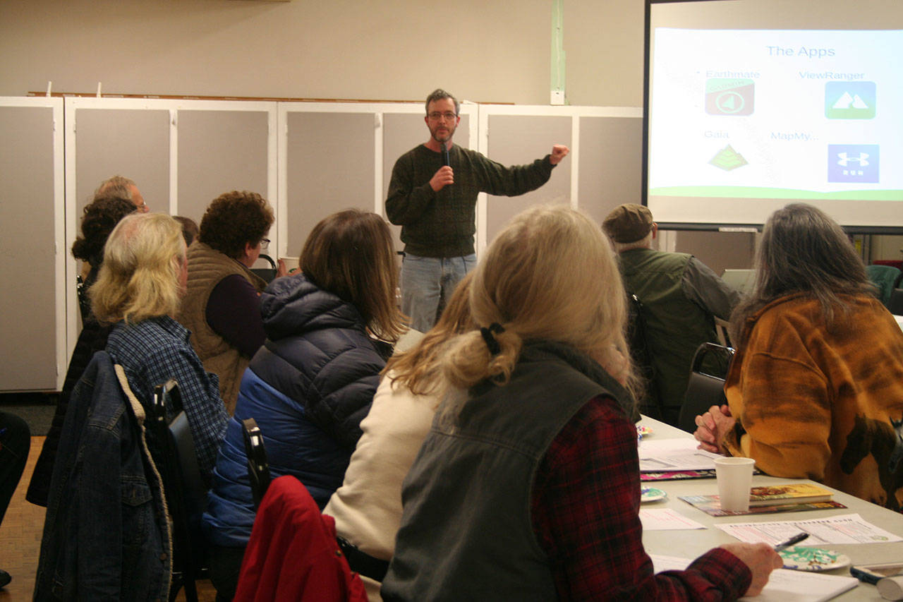 Back Country Horsemen’s Buckhorn Range Chapter hosts Daniel Heaton, Port Townsend library’s technical services manager, to explain types of GPS apps for smartphones to use for tracking, navigation and fitness, along with the benefits of equestrians, hikers and bikers going into the backcountry with a dedicated GPS device at this month’s meeting. (Karen Griffiths/for Peninsula Daily News)