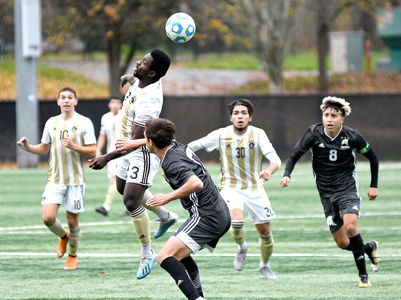 Peninsula’s Theodore Baiye heads a ball against Tacoma in the NWAC championship match Sunday. The Pirates won in 3-1 in penalty kicks after the game ended in a 1-1 tie. Also in on the play are the Pirates’ Mason Haubrich (10) and Jonathan De Motta (30). (Photo courtesy of Peninsula College)