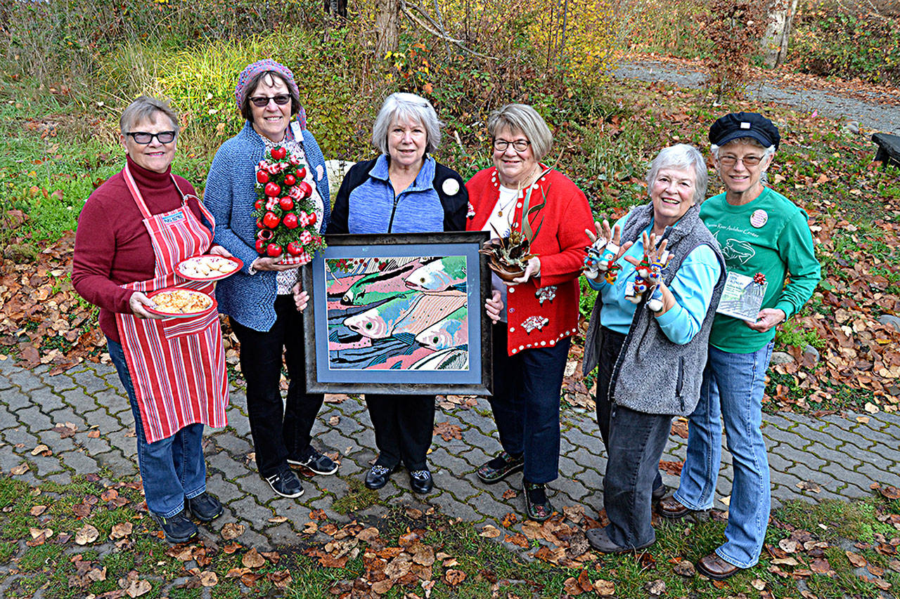 Committee members for the River Center Holiday Nature Mart from left, Syrene Forsman, Marion Rutledge, Wanda Schneider, Tuttie Peetz, Shirley Anderson and Gretha Davis show off some of the goods and wares available at the fundraiser for the center from 10 a.m. to 4 p.m. today and Saturday at the Red Cedar Hall, 1033 Old Blyn Highway. (Matthew Nash/Olympic Peninsula News Group)