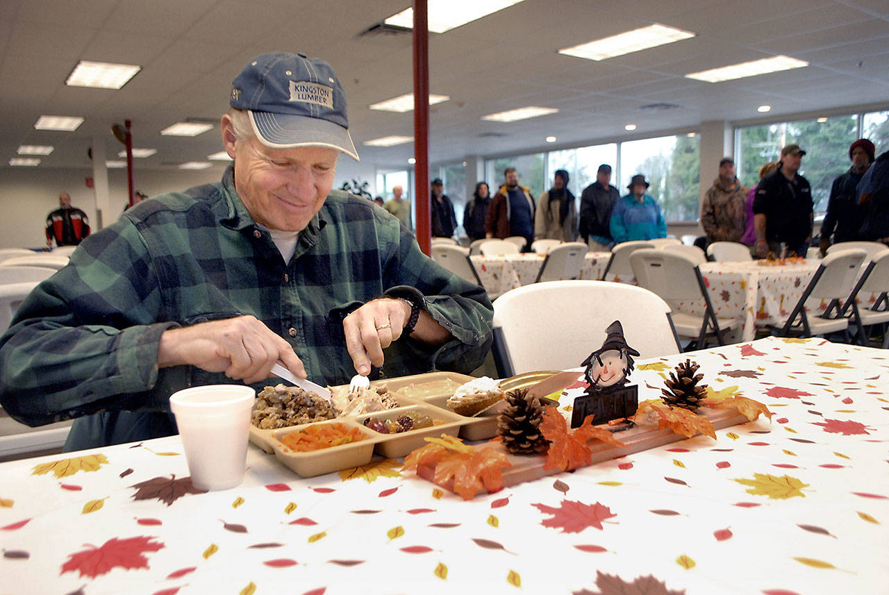 John Yeo of Sequim sits down to a traditional turkey dinner during Wednesday’s Thanksgiving Eve meal at the Port Angeles Salvation Army kitchen. (Keith Thorpe/Peninsula Daily News)