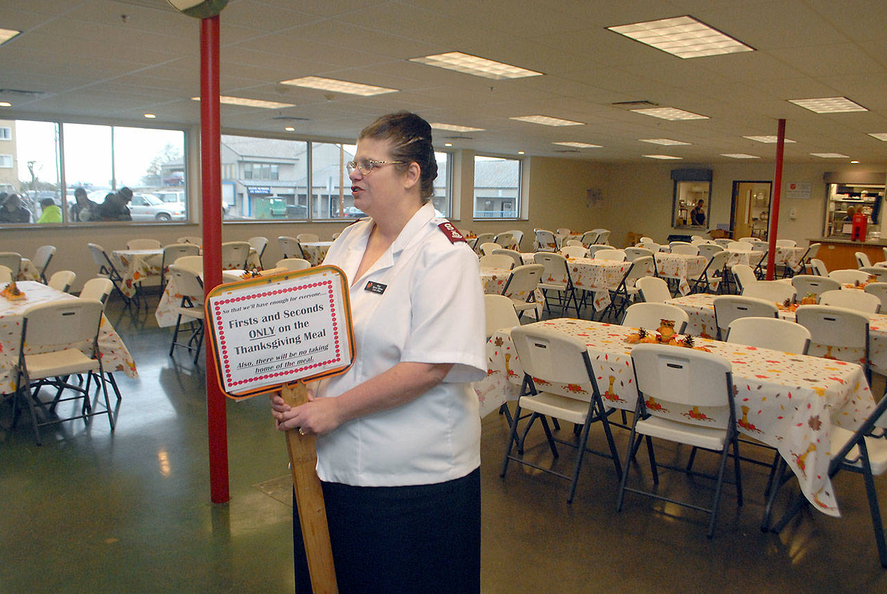 Salvation Army Major Barbara Wehnau leads a prayer of thanks before opening up the dining hall for Wednesday’s Thanksgiving Eve meal in Port Angeles. (Keith Thorpe/Peninsula Daily News)