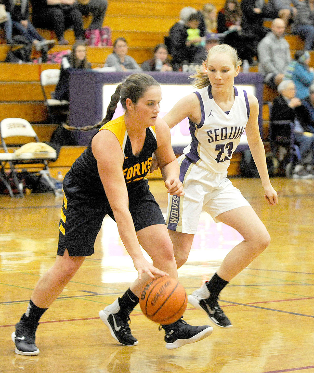 Forks’ Rian Peters, left, is one of the Spartans mainstays returning this season. Defending her is Sequim’s Melissa Porter in a game last season. (Michael Dashiell/Olympic Peninsula News Group)