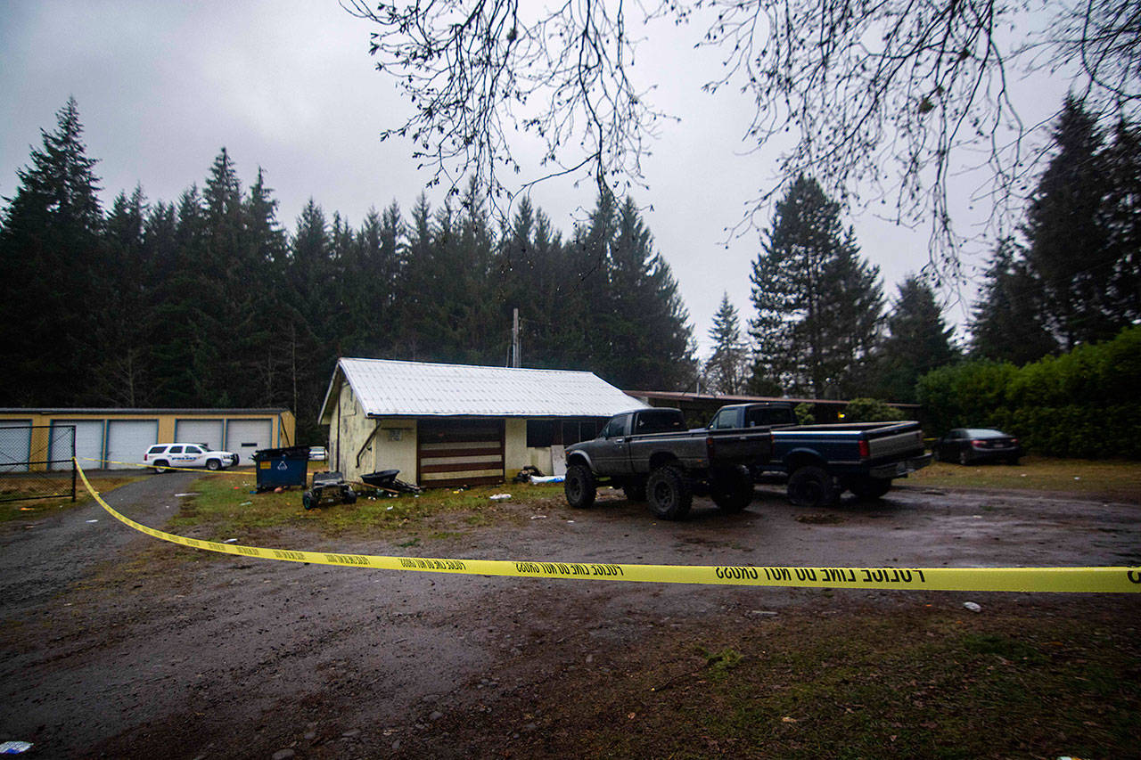 Crime scene tape surrounds a house on the 1300 block of Big Burn Place in Forks where investigators said a 17-year-old boy shot and killed a 19-year-old man after an early-morning party Sunday. (Jesse Major/Peninsula Daily News)