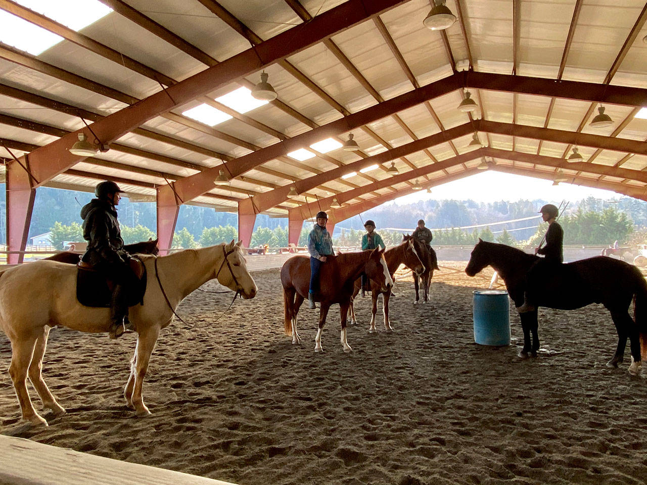 During last month’s Freedom Farm Hoof Beat classes the theme was No Stirrups, No Tack November. In its final class, instructor Jessica Crouch re-emphasized the need for riders Ellie Damm, from left, Kathryn Bleiweiss, Haleyanna Fell and Elise Dean, to pay close attention to the Three C’s: connection, communication and collaboration with their horses when riding without a bridal or saddle. (Mary Tulin)