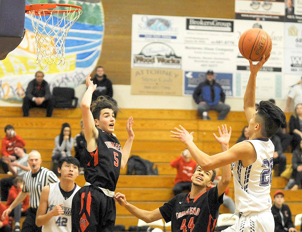Port Townsends Lonnie Kenny (5) and Devin Harriss (44) defend against Sequim on Monday. (Conor Dowley/Olympic Peninsula News Group)