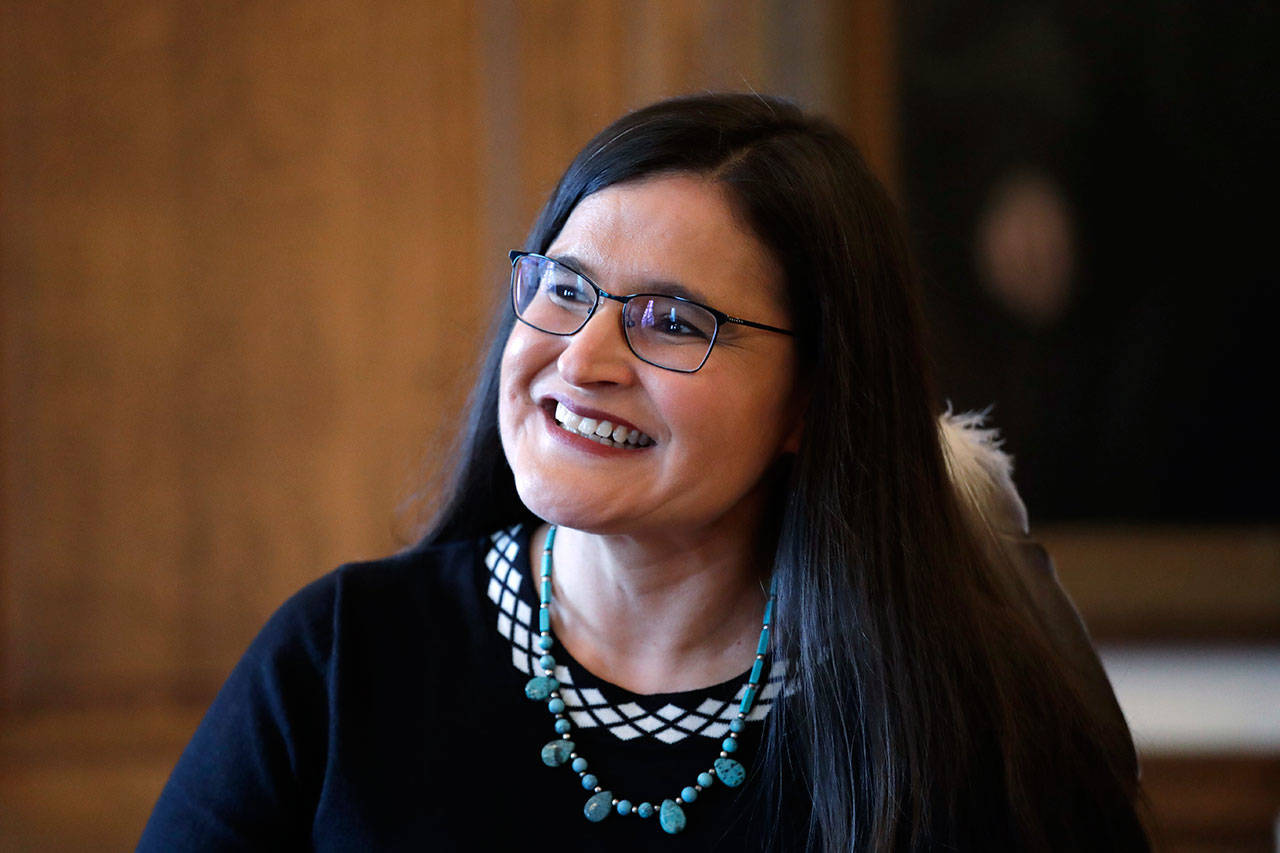 Whatcom County Superior Court Judge Raquel Montoya-Lewis, wearing an eagle feather honoring her Native American heritage, smiles as she speaks with media members after being named to the state Supreme Court on Wednesday in Olympia. (Elaine Thompson/The Associated Press)