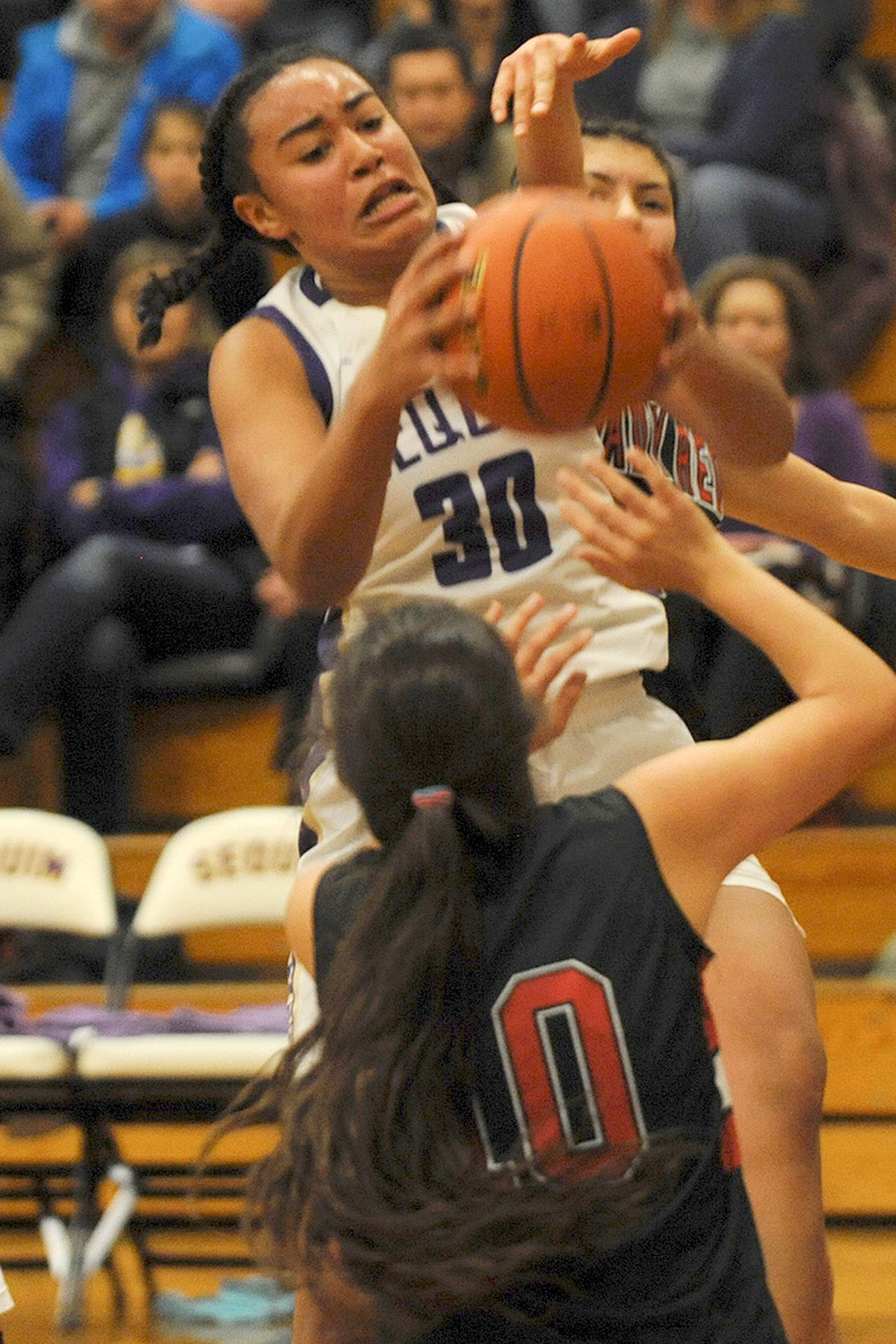 Jayla Julmist (30), comes down with an offensive rebound over Neah Bay’s Allie Greene (10) during Sequim’s 86-63 win over the Red Devils on Wednesday. (Conor Dowley/Olympic Peninsula News Group)