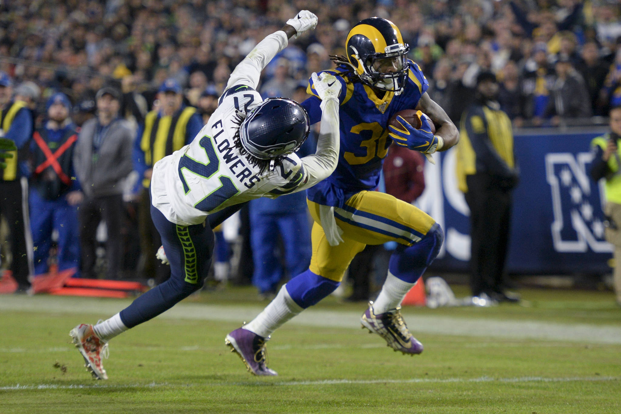 Los Angeles Rams running back Todd Gurley, right, scores past Seattle Seahawks cornerback Tre Flowers during the second half of an NFL football game Sunday, Dec. 8, 2019, in Los Angeles. (AP Photo/Kyusung Gong)