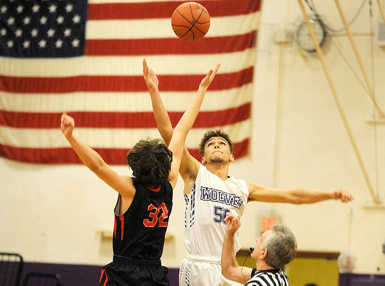 Sequims Hayden Eaton (50) goes up for a jump ball against Port Townsends Evan Toner (32) on Monday. Eaton had 14 points and 13 rebounds in the Wolves 67-55 win. (Conor Dowley/Olympic Peninsula News Group)