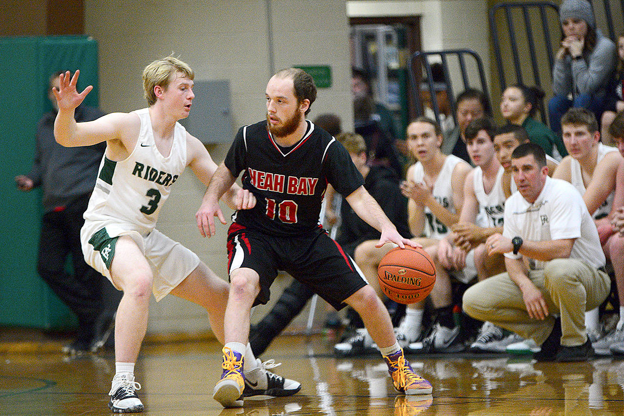 Neah Bay’s Meric Soeneke dribbles while guarded by Port Angeles’ Brady Nickerson during their game Wednesday. (Jesse Major/Peninsula Daily News)