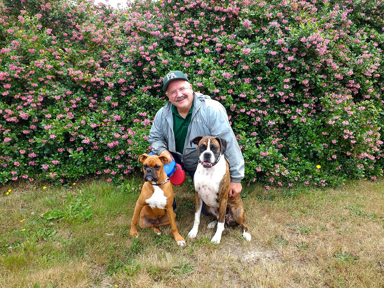 Port Angeles High School teacher Peter Rennie is pictured with Tripp, left, and Oscar.