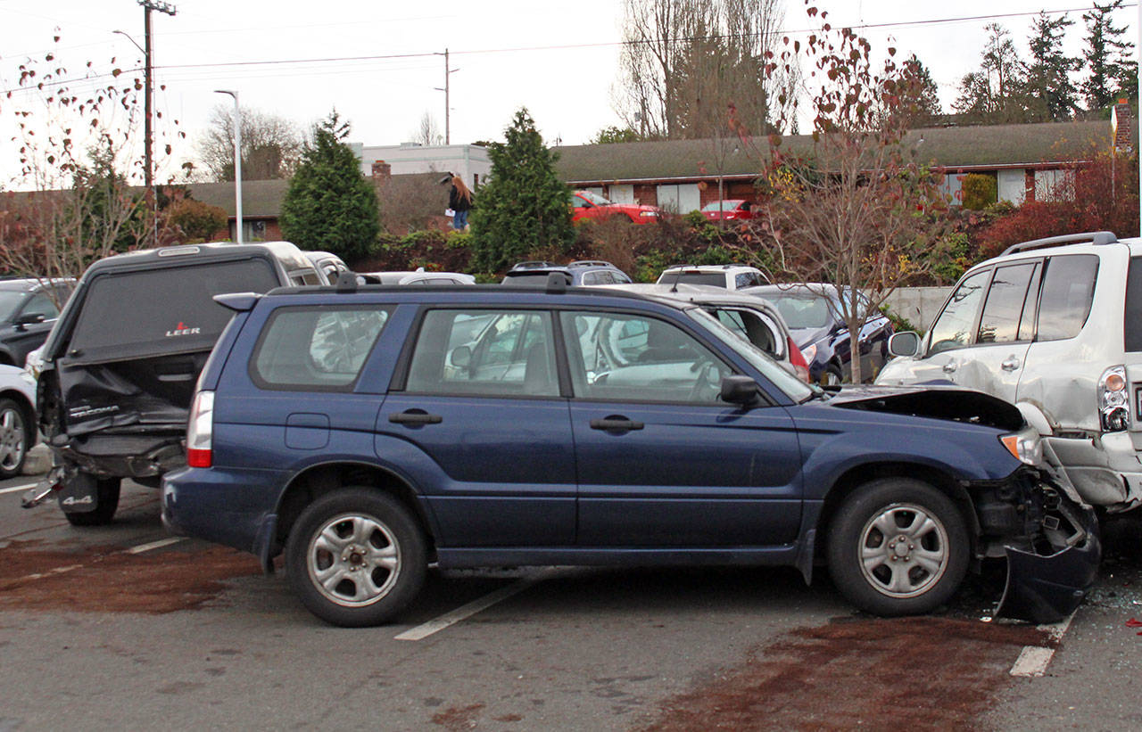 A Suburu Forester hit three other parked vehicles, pushing the third into two others, in the parking lot of Jefferson Healthcare this morning. (Zach Jablonski/Peninsula Daily News)