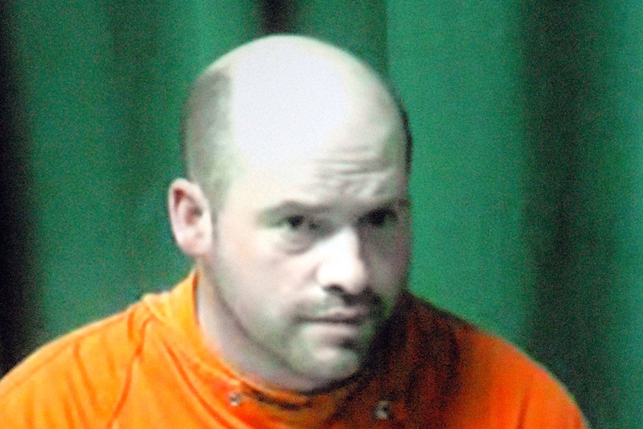 Keith Thorpe/Peninsula Daily News Ryan Warren Ward, 37, appears by video link during his first appearance in Clallam County Superior Court in Port Angels on Thursday on charges of aggravated first-degree murder with firearms enhancements related to a triple homicide in December.Inset in the two-way video appearance is Superior Court Judge Brian Coughenour.