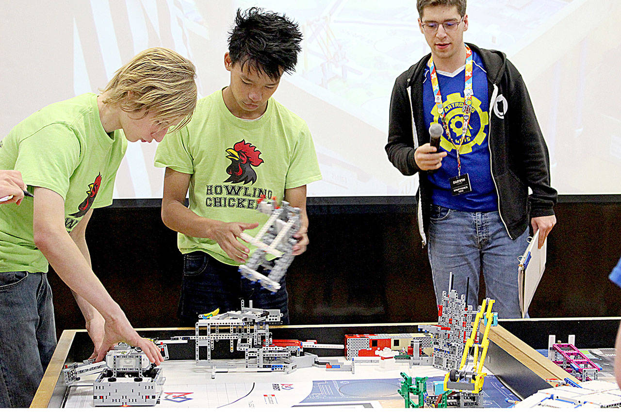 Evan Mackey, left, and teammate Timothy Heemstra compete in the Robot Game portion of the FIRST Lego League Peninsula Qualifier on Dec. 7 at Bainbridge Island High School. (Discovery 4-H)