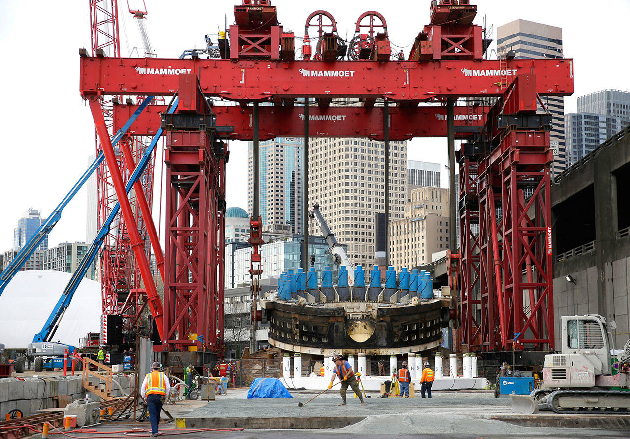 A massive crane is used on March 30, 2015 to lift a 2,000-ton section of the tunnel-boring machine known as “Bertha” that was stalled underground in Seattle and awaiting repairs while digging the tunnel to replace Seattle’s elevated Alaskan Way Viaduct roadway. (Ted S. Warren/The Associated Press)