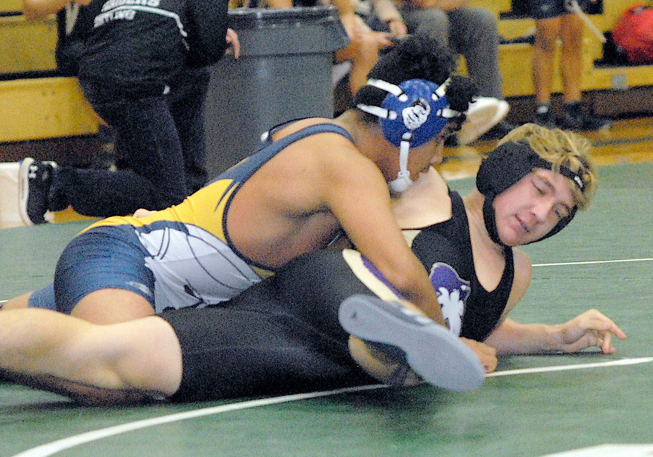 Forks’ Luis Perez attempts to pin Sequim’s Truman Nestor during a wrestling jamboree at Port Angeles High School earlier this month. (Keith Thorpe/Peninsula Daily News)