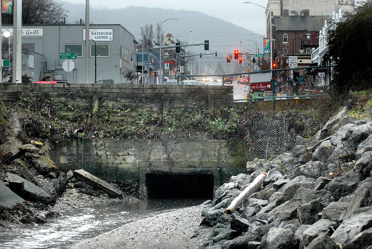 Water flows Thursday from an aging culvert that steers Peabody Creek into Port Angeles Harbor. (Keith Thorpe/Peninsula Daily News)