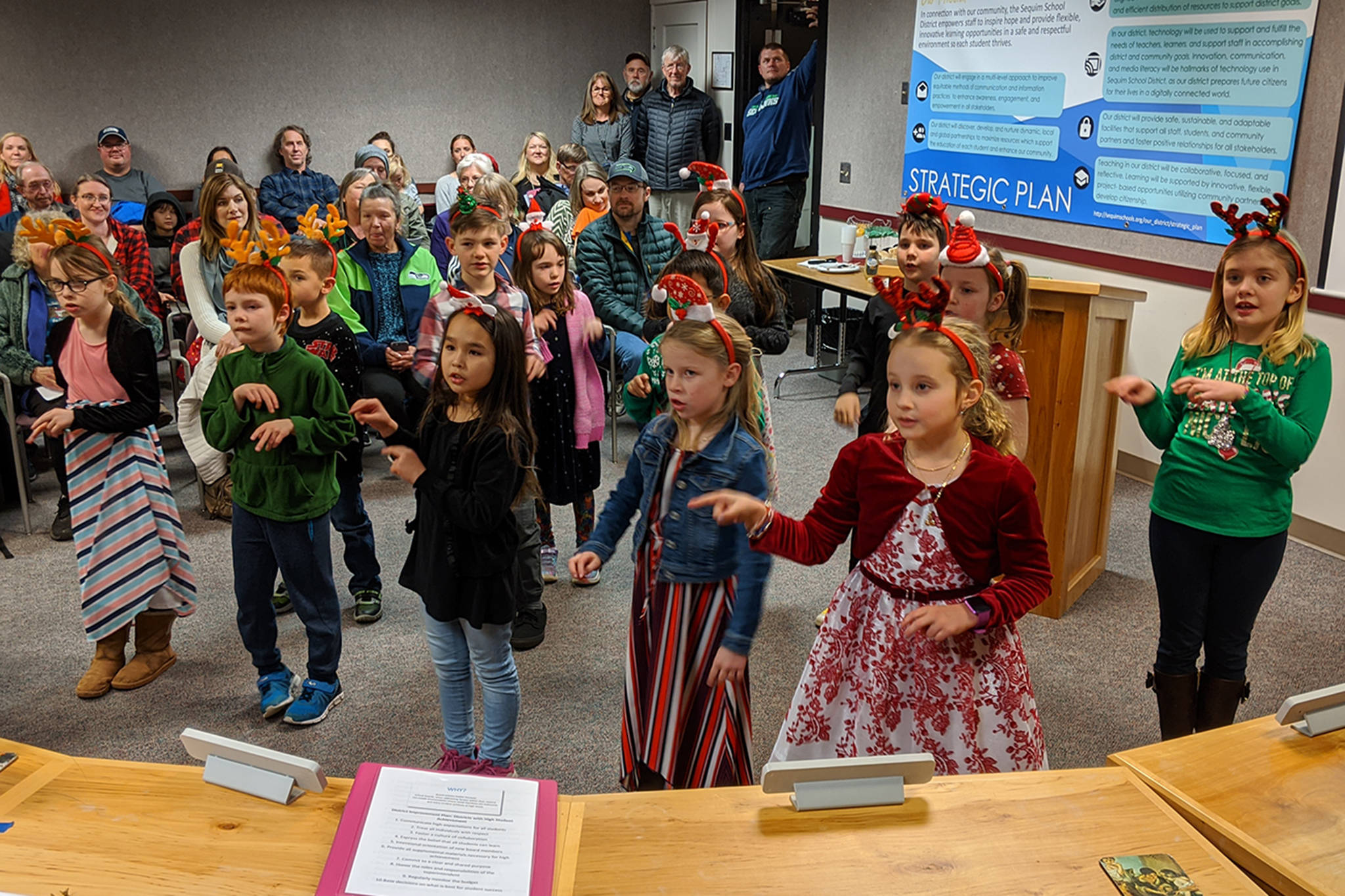 The Haller Elves sing and sign Christmas carols to the Sequim School Board. (Conor Dowley/Olympic Peninsula News Group)