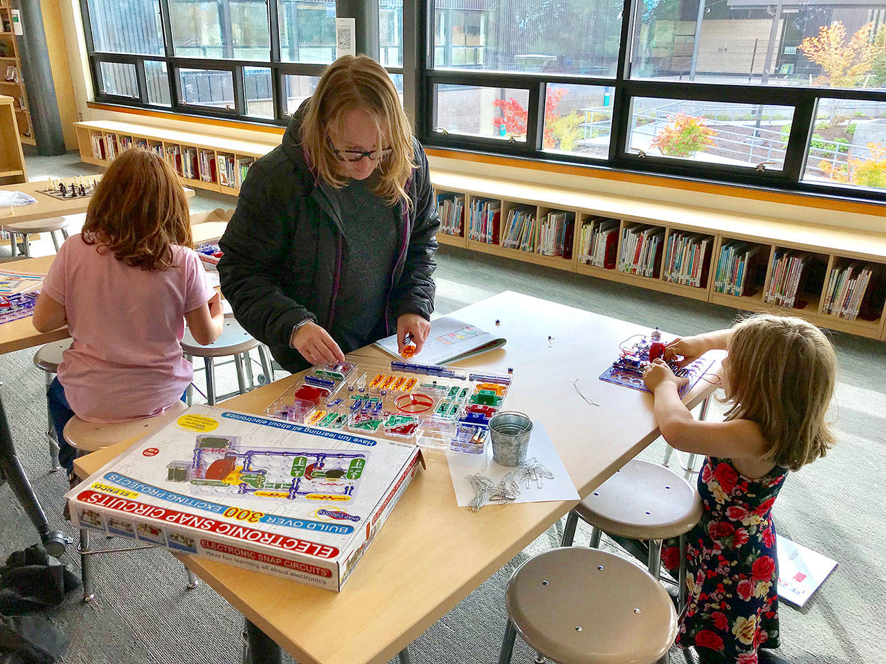 Youth Services Library Manager Hilary Verheggen leads two Salish Coast Elementary School students in a lesson on how to create snap circuits. The snap circuits have been so popular at the Salish After Hours program that organizers had to buy more sets, Port Townsend library director Melody Eisler said. (Port Townsend Public Library)