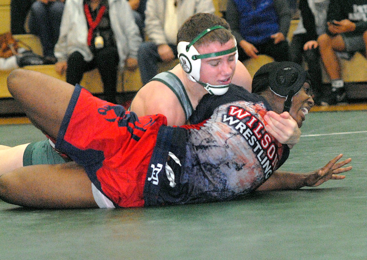 Keith Thorpe/Peninsula Daily News Port Angeles’ Josh Boe works to contain Wilson’s Kedrick Bennett in the 145-lb. class on Saturday at Port Angeles High School.