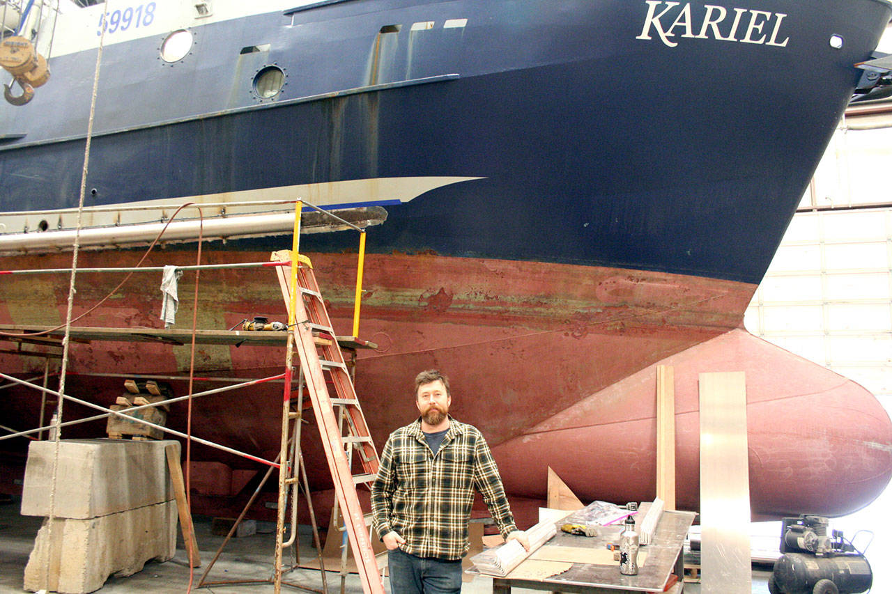 Arren Day, the president of the Port Townsend Shipwright’s Co-op, stands in front of the Kariel of Sitka, Alaska. Day said his crew is working to re-configure the boat for 150 pots that are each 6 feet in diameter to replace a system with 8,000 hooks on 8 miles of line, because sperm whales are taking bites out of the fish. (Brian McLean/Peninsula Daily News)