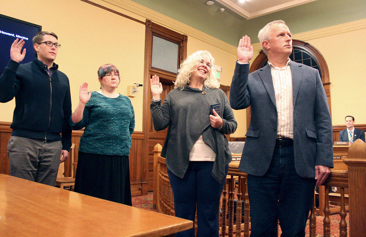 From left, Port Townsend City Council members David Faber, Amy Howard, Monica MickHager and Owen Rowe simultaneously take the oath of office Monday night. Faber and Howard were re-elected in November, while MickHager and Rowe began their first four-year terms. (Brian McLean/Peninsula Daily News)