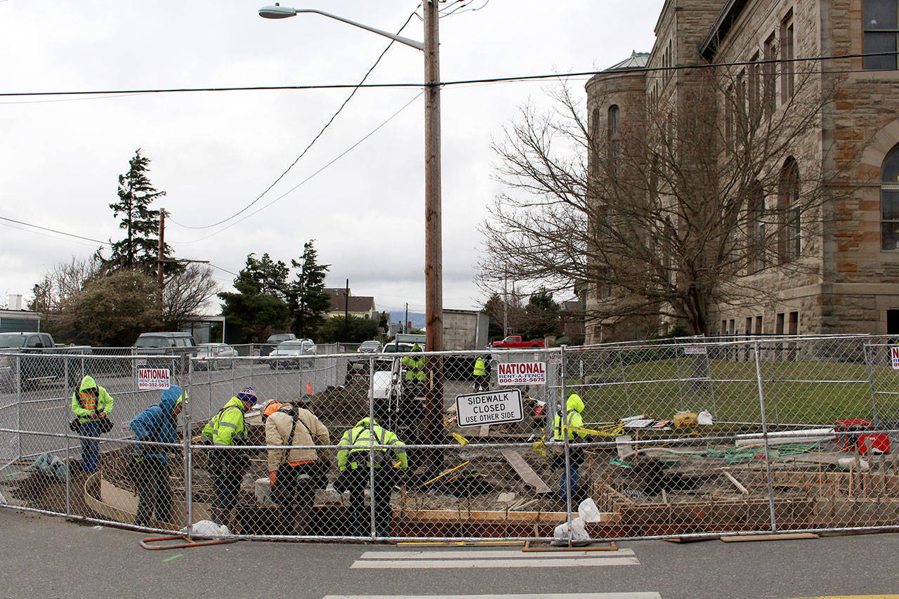 Workers from Rocky Bay Construction work on the Port Townsend Post Office Curb Extension project Tuesday afternoon on the corner of Washington and Harrison streets. The Post Office project includes modifications to the sidewalk and streets, including new bulbouts, stormwater facilities and four ADA ramps. (Zach Jablonski/Peninsula Daily News)