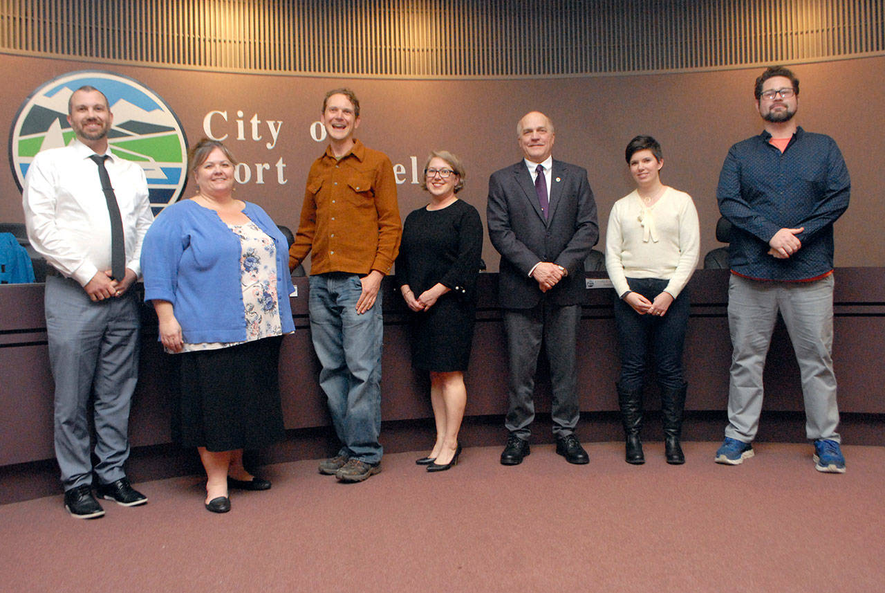 Port Angeles City Council members gather for a group photo prior to the start of Tuesday night’s council meeting. They are, from left, Mike French, LaTrisha Suggs, Lindsey Schromen-Wawrin, Mayor Kate Dexter, Charlie McCaughan, Deputy Mayor Navarra Carr and Brendan Meyer. (Keith Thorpe/Peninsula Daily News)