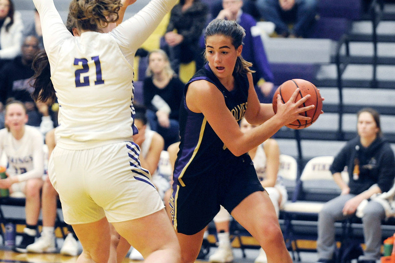 Sequim’s Hope Glasser (right) drives into the lane against North Kitsap Vikings forward Georgia Tucker in the Wolves’ 55-45 win over the Vikings on Tuesday. (Conor Dowley/Olympic Peninsula News Group)