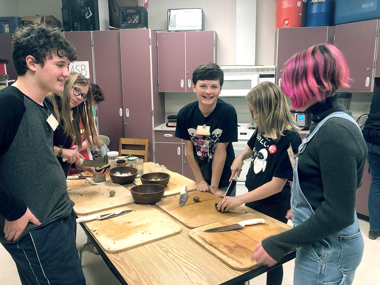 Students at Blue Heron Middle School participate in a cooking class put on by the Food Co-op. Pictured are Callen Johnson, left, Samara Kingfisher, Cadin Keever, Eden Jackson, and Sage Brotherton. (Zach Jablonski | Peninsula Daily News)