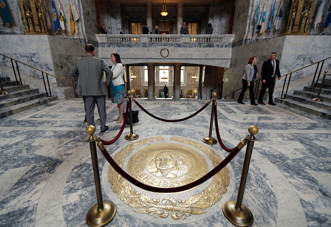 The Washington state seal is protected by ropes in the rotunda of the Legislative Building at the Capitol in Olympia on April 22, 2019. The 60-day legislative session in Washington state begins today with lawmakers set to make adjustments to the state budget as well as tackle several policy issues, including how to address homelessness in the state. (Ted S. Warren/The Associated Press)