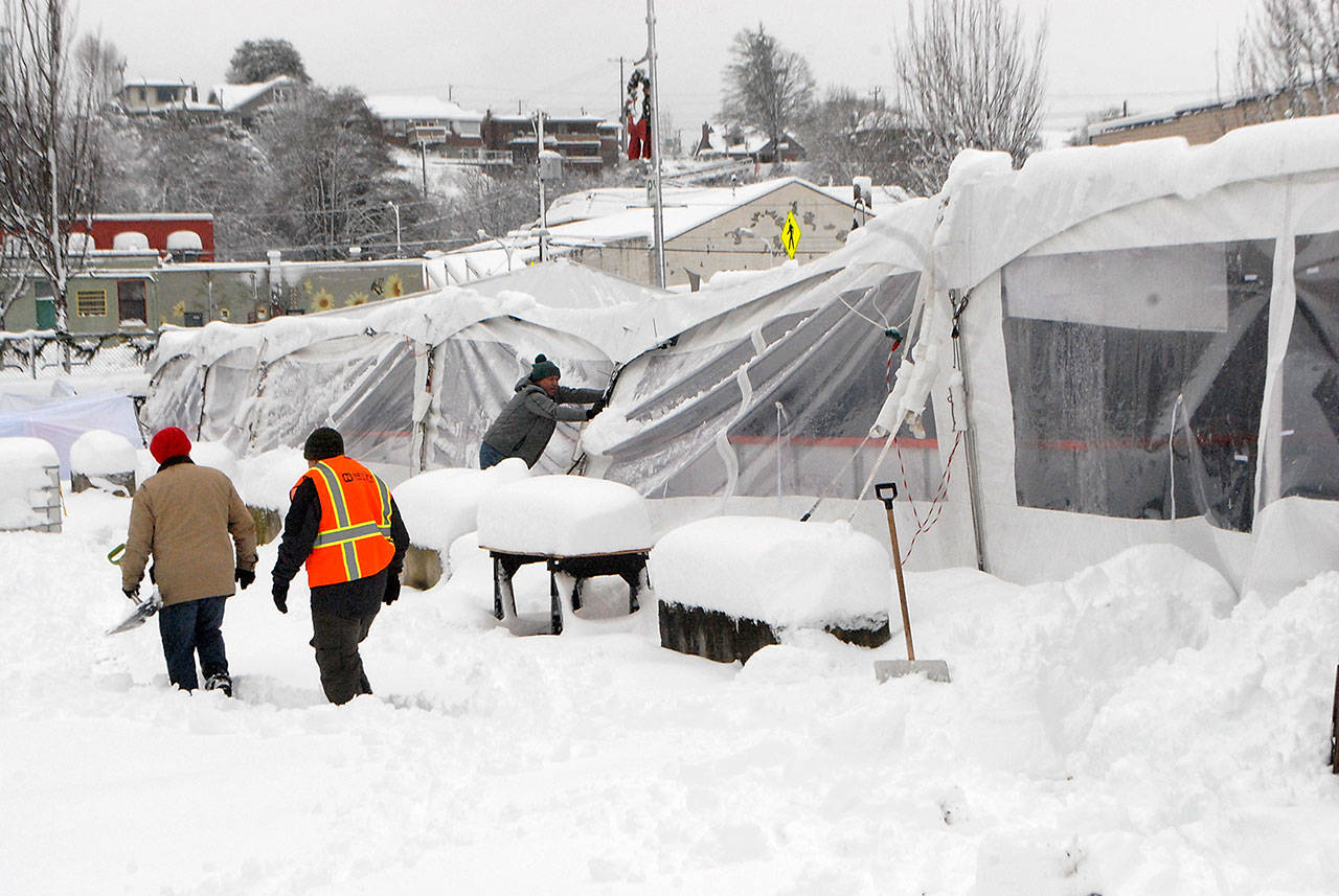 The collapsed tent covering the ice skating rink at the Port Angeles Winter Ice Village sags under the weight of tons of snow on Wednesday morning. (Keith Thorpe/Peninsula Daily News)