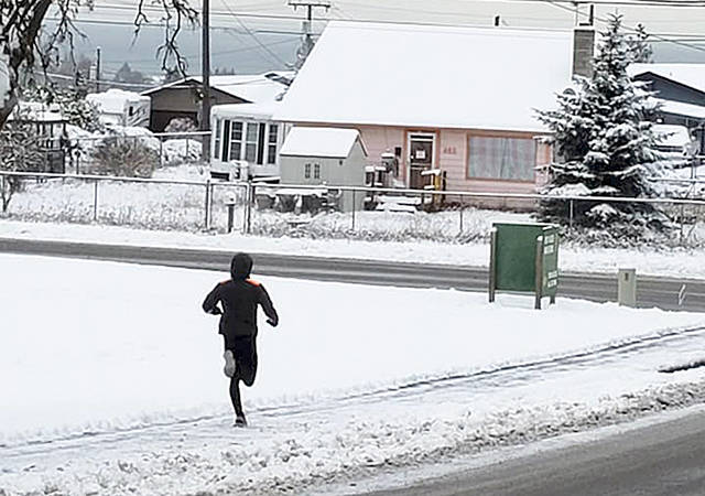 Port Angeles wrestler Adam Borde was spotted training on his own during the recent snowy weather in Port Angeles. With schools closed Monday through Thursday in Port Angeles, Roughrider athletes had to take training methods into their own hands. (Rob Gale/Port Angeles Wrestling)