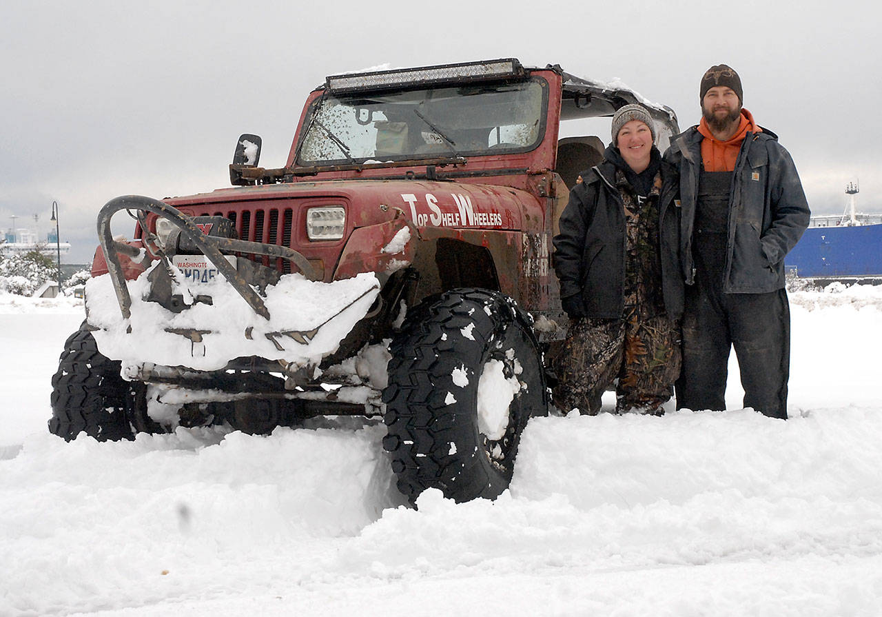Top Shelf Wheelers ORC members Valerie and Steve Menkal of Port Angeles, shown with their 1987 Jeep Wrangler, have made themselves available to assist others with snow emergencies. (Keith Thorpe/Peninsula Daily News)