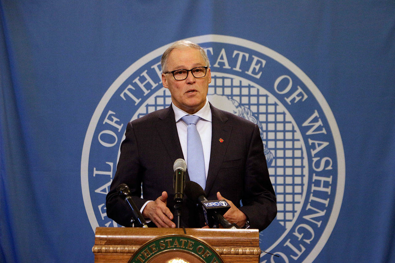 Washington Gov. Jay Inslee talks to the media after a state Supreme Court ruling that reinstated a severely limited version of his plan to cap carbon pollution in the state in Olympia. He said the ruling just strengthens his commitment to get climate change-related bills through the Legislature this year. (Rachel La Corte/The Asociated Press)