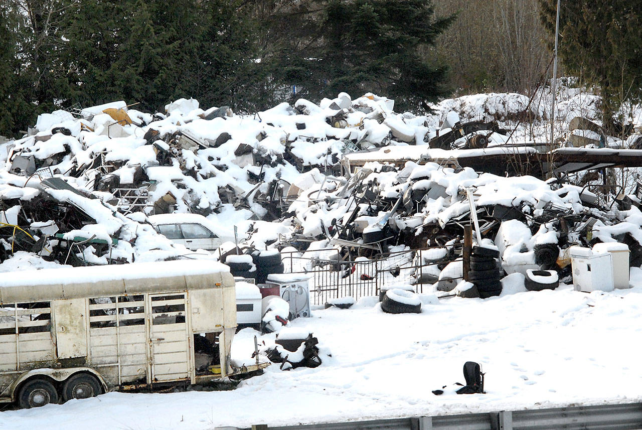 Heaps of discarded appliances and scrap metal lay covered in snow on Saturday at Midway Metals, 258010 Highway 101 between Port Angeles and Sequim. (Keith Thorpe/Peninsula Daily News)
