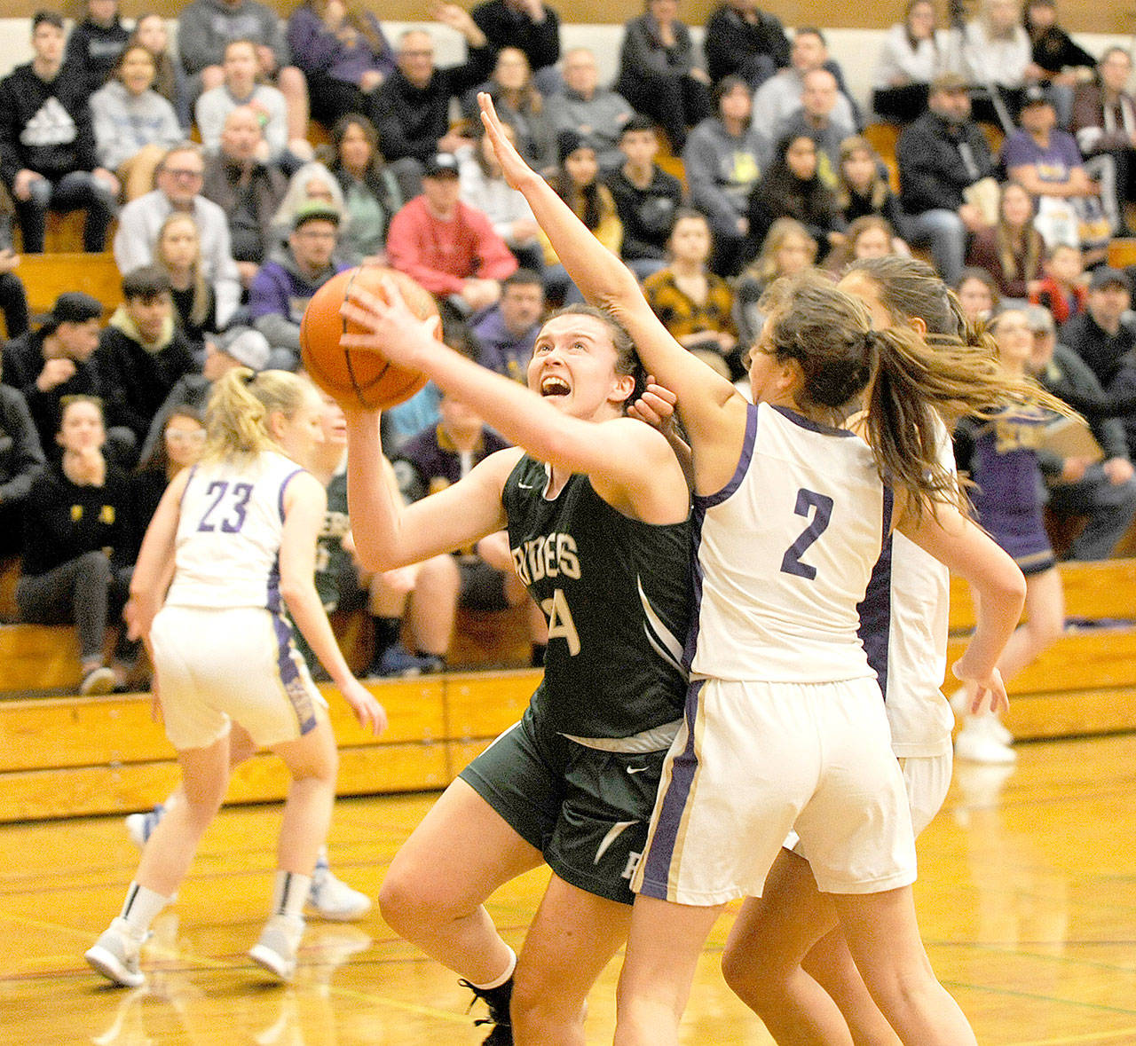 Port Angeles’ Jaida Wood goes up for a shot against Sequim’s Jessica Dietzman in Sequim on Saturday. (Michael Dashiell/Olympic Peninsula News Group)