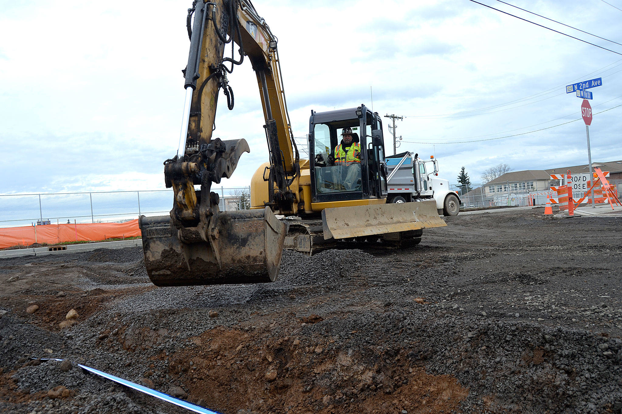 Work continued Monday along West Fir Street after snow delayed Interwest Construction for a week. Here, crewmen cover irrigation pipeline at the Second Avenue and Fir Street intersection. (Matthew Nash/Olympic Peninsula News Group)