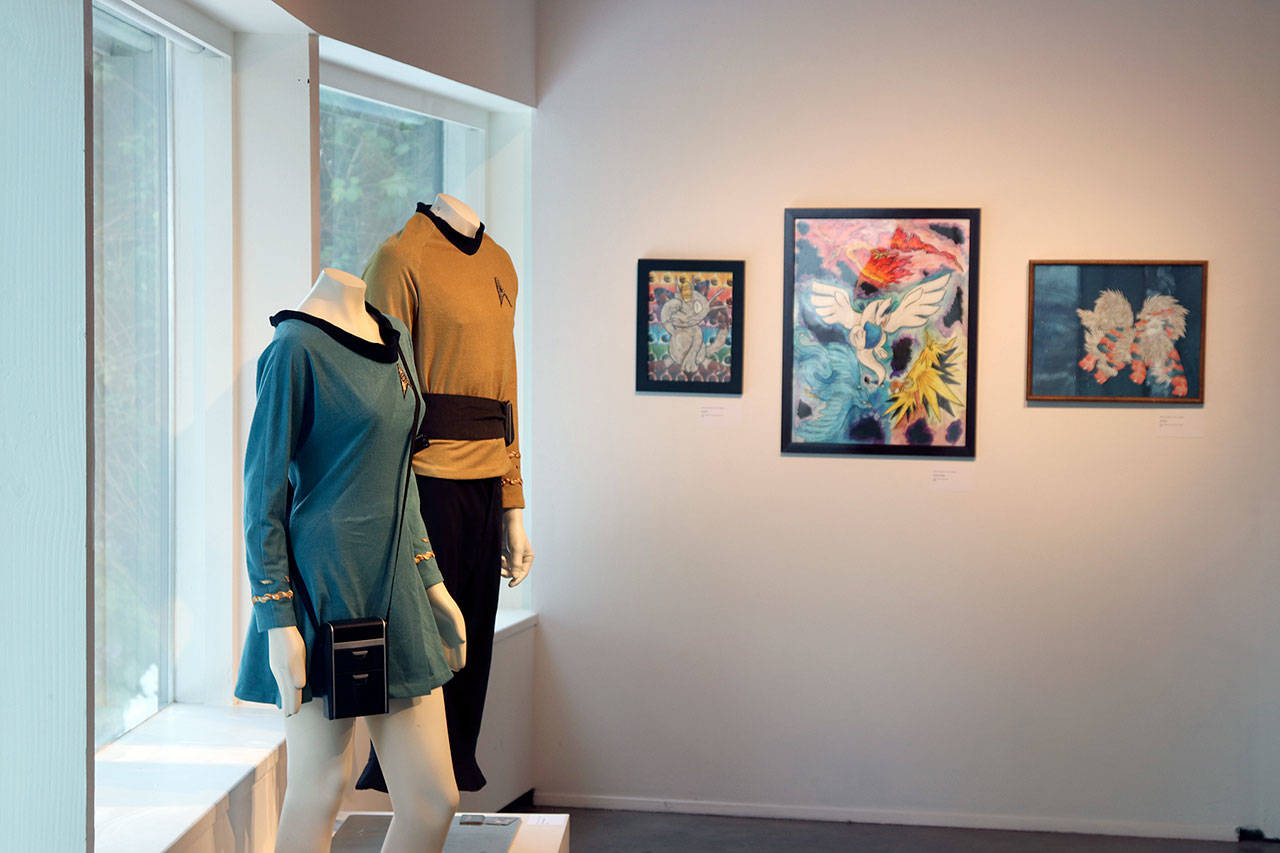 Star Trek Original Series costumes constructed by Chris Corbitt and Alicia Faires of Mount Vernon are displayed near Pokemon-inspired mixed-media artworks by Britney Robinson of Port Angeles at the Obsessed: The Art of Nerd-dom exhibit at the Port Angeles Fine Arts Center. (Sarah Jane/Port Angeles Fine Arts Center)