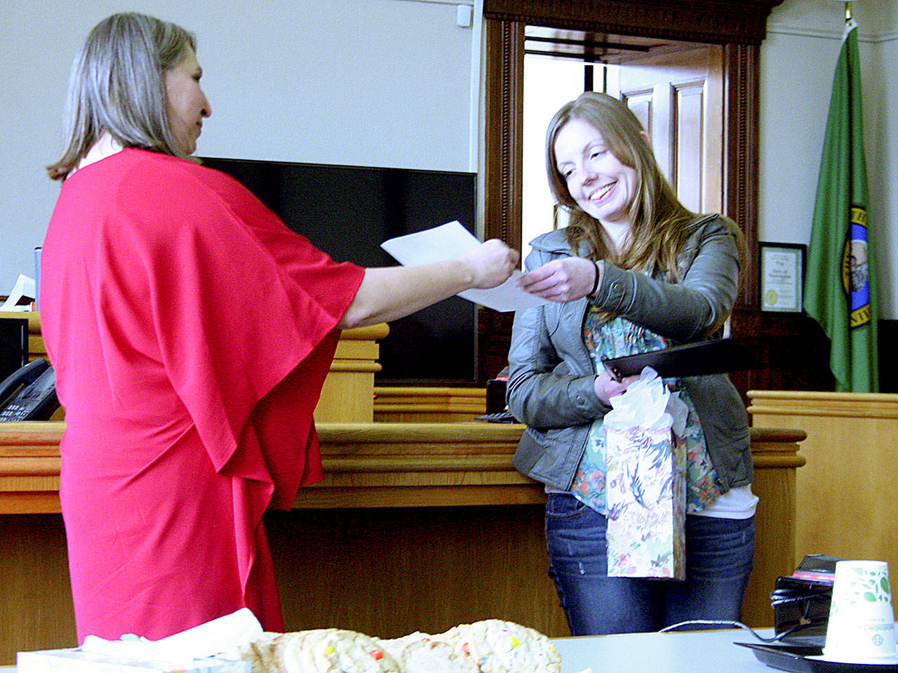 Jefferson County District Court Judge Mindy Walker, left, congratulates Amanda Bowers and provides a certificate of completion for the county’s behavioral health program. Bowers is the 14th person to graduate from the program that was instituted by Judge Jill Landes in 2013. (Brian McLean/Peninsula Daily News)