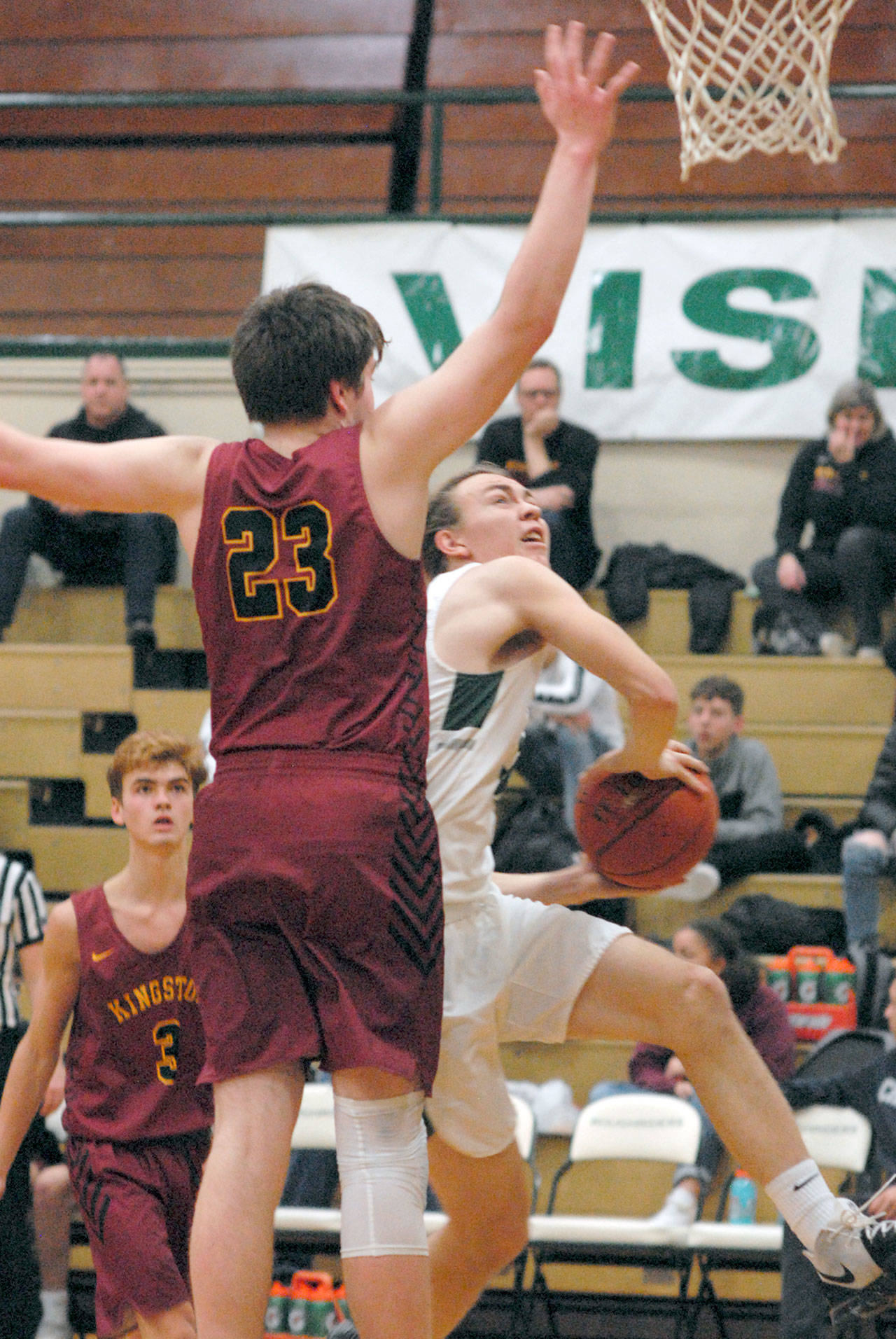 Port Angeles’ Derek Bowechop, right, sets for a layup while defended by Kingston’s Dylan Baze on Wednesday at Port Angeles High School. (Keith Thorpe/Peninsula Daily News)