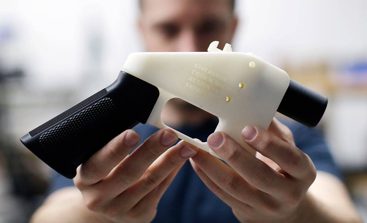 In this 2018 photo, Cody Wilson, with Defense Distributed, holds a 3D-printed gun called the Liberator at his shop in Austin, Texas. Washington Attorney General Bob Ferguson on Thursday filed a multistate lawsuit that again seeks to block the Trump Administration from allowing 3D-printed gun files to be released on the internet. (Eric Gay/The Associated Press)