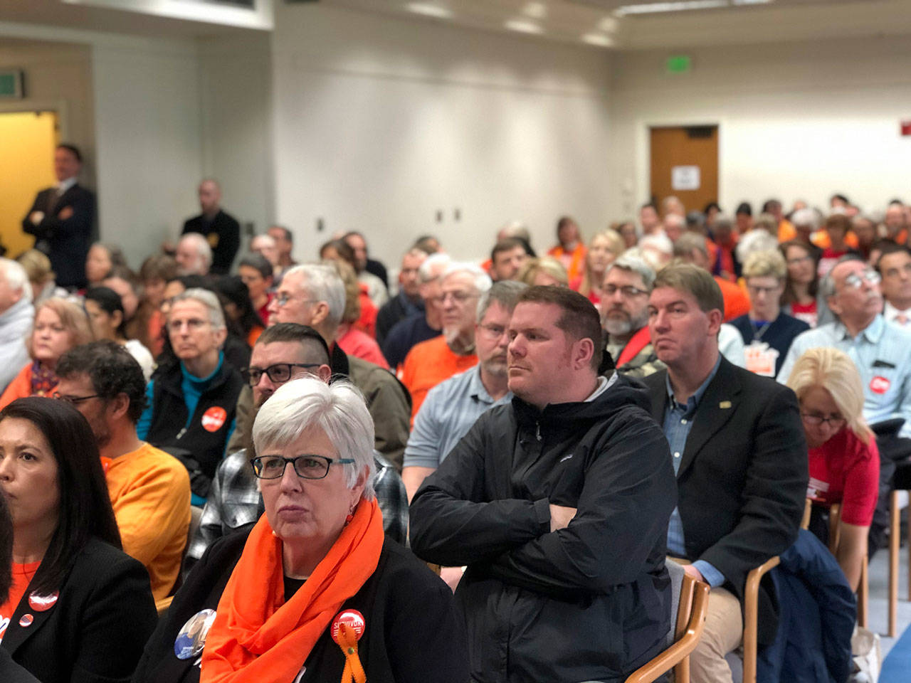 Washington residents listen during a state Senate Law and Justice Committee hearing on a proposed ban on high capacity gun magazines. Many wore orange in support of gun safety. (Leona Vaughn/WNPA News Service)