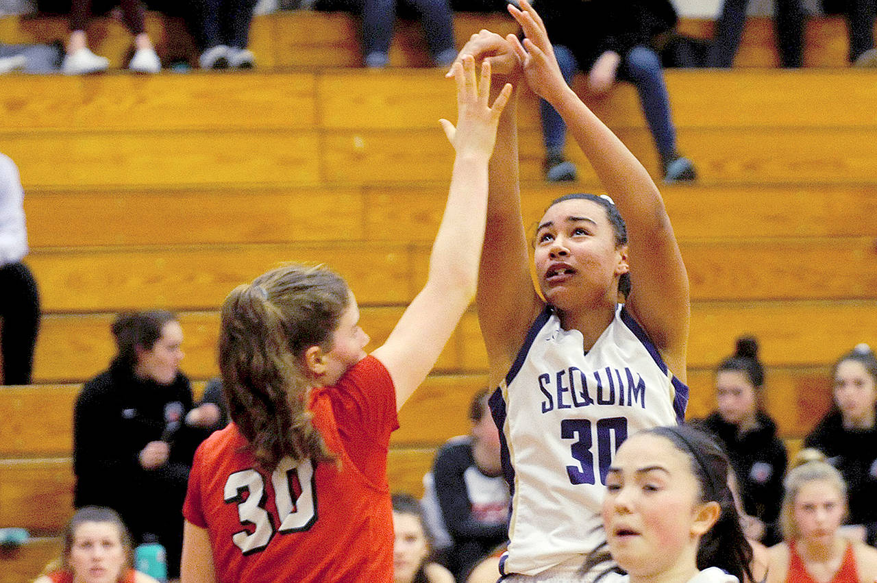 Sequims Jayla Julmist (30) pulls back and takes a shot after stealing the ball and running up the court on a fast break in the second quarter of the Wolves 60-52 win ove Kings on Wednesday. Julmist made her return from a knee injury, scoring seven points with eight rebounds, three blocks and two steals. (Conor Dowley/Olympic Peninsula News Group)