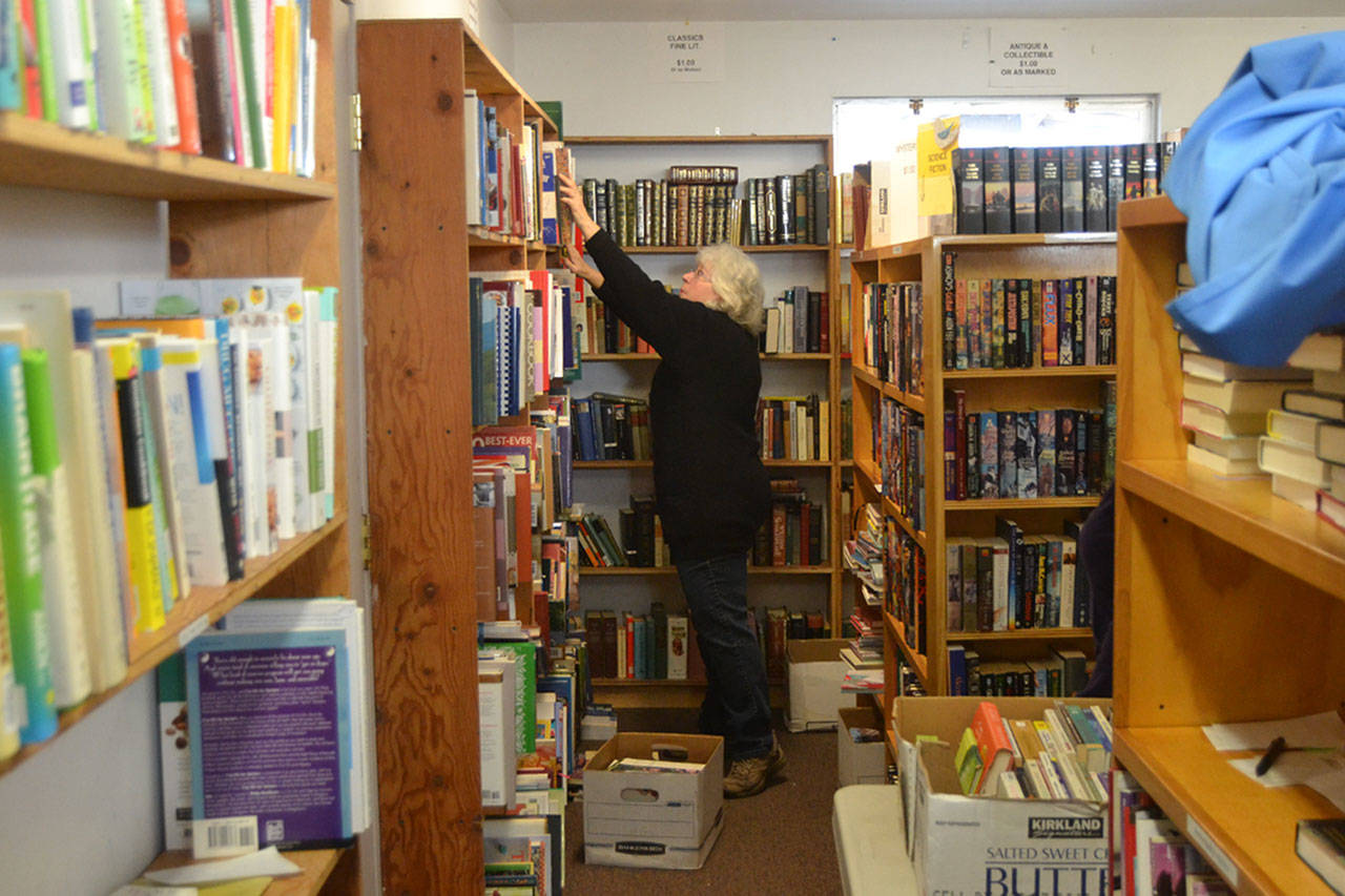 Volunteer Margaret Yates shelves books for the Friends of Sequim Library book sale on Feb. 8. (Matthew Nash/Olympic Peninsula News Group )