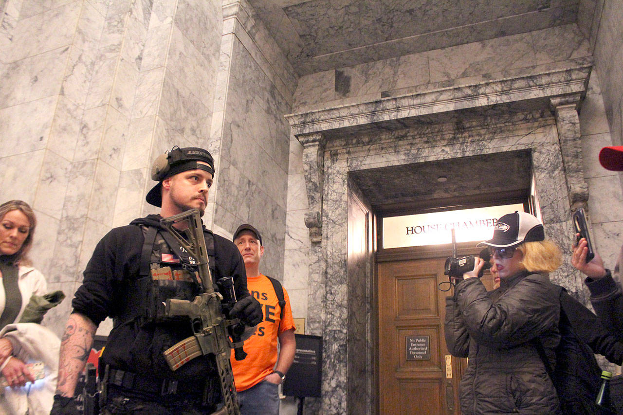 A gun-rights advocate warns a crowd of the potential need for forceful resistance in the future at a gathering outside the state House of Representatives chamber in Olympia. (Cameron Sheppard/WNPA News Service)