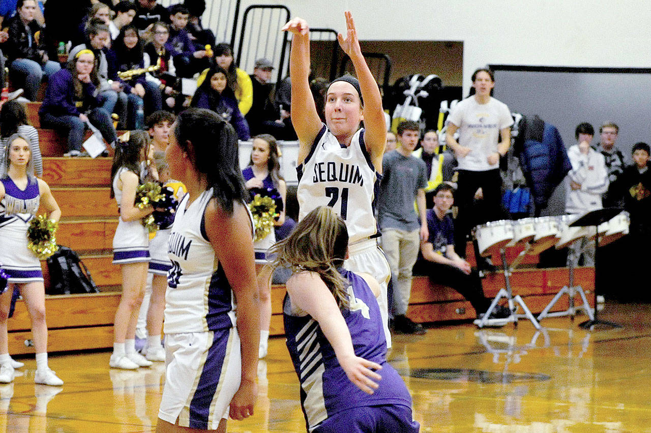 Conor Dowley/Olympic Peninsula News Group for all of them. Kalli Wiker (21) takes a 3-point shot in the fourth quarter of the Wolves’ 78-49 win over the North Kitsap Vikings on Jan. 31. Wiker tied the overall Sequim High School record (set by Art Green in 1991) for 3-pointers made in a single game with eight for the second time this season, and led the team with 27 points on the night.