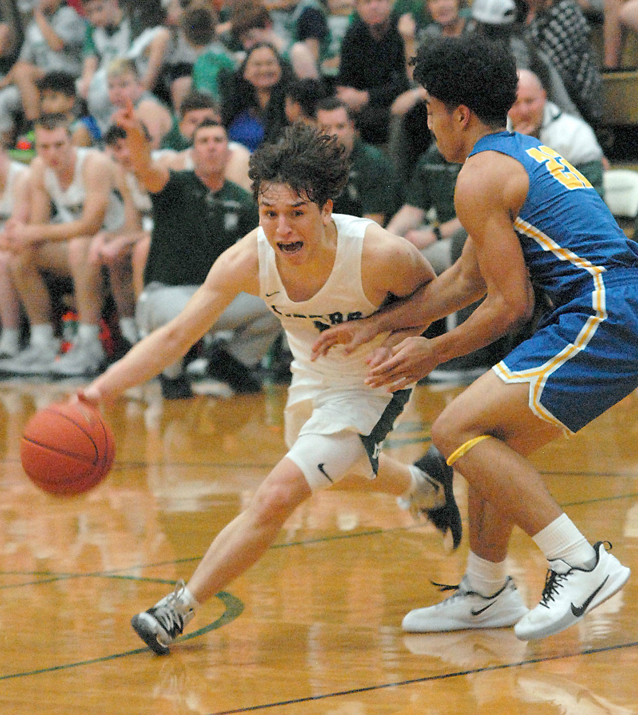Port Angeles Gary Johnson, left, swings past the defense of Bremertons Kaipo Retome on Tuesday in Port Angeles. (Keith Thorpe/Peninsula Daily News)